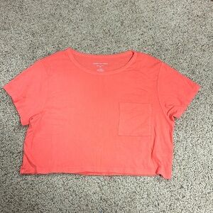 This crop top is from American Eagle, it’s a size L, and it’s coral pink